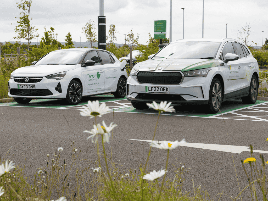 Two electric vehicles parked at public EV charging bays, highlighting electric vehicle charging infrastructure, sustainable transport and the growing adoption of zero-emission vehicles.