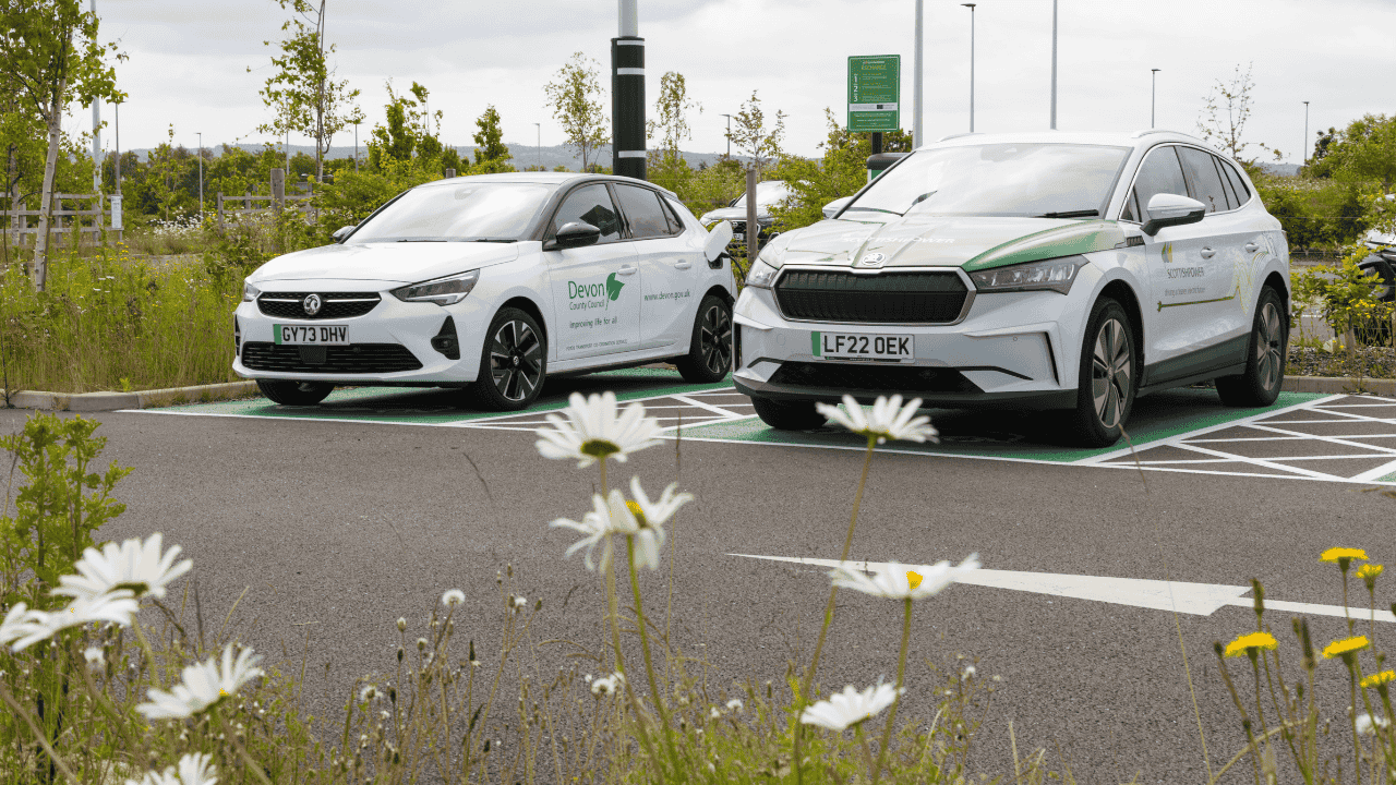 Two electric vehicles parked at public EV charging bays, highlighting electric vehicle charging infrastructure, sustainable transport and the growing adoption of zero-emission vehicles.