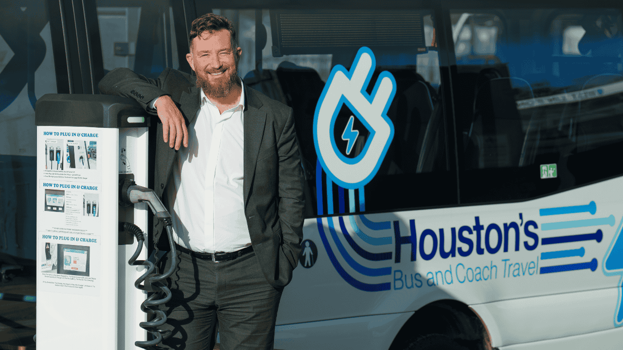 Electric vehicle charging station next to an electric bus, illustrating how public EV charging infrastructure supports sustainable transport and fleet electrification.