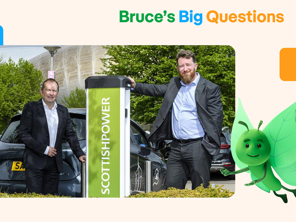 Two men at an electric vehicle charging point, highlighting how public EV charging infrastructure supports sustainable transport and local business growth.