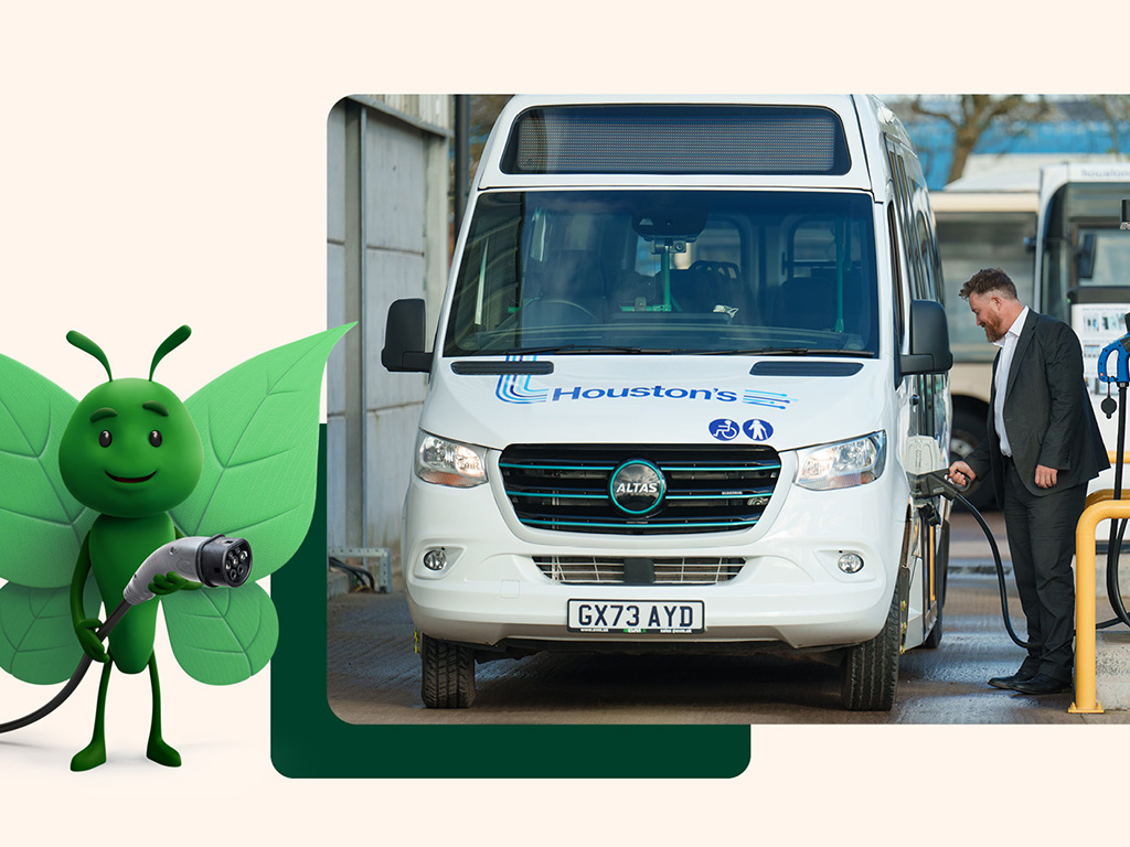 man plugging EV charger in to a bus