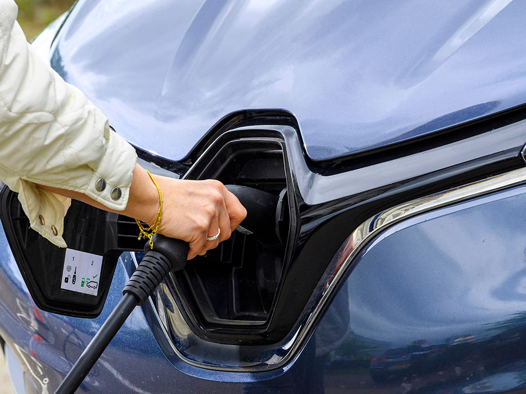 Woman charging EV