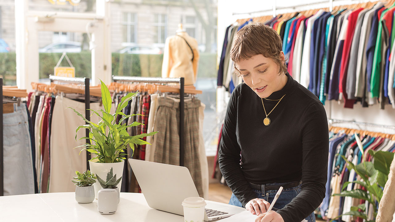 Woman in shop writing notes