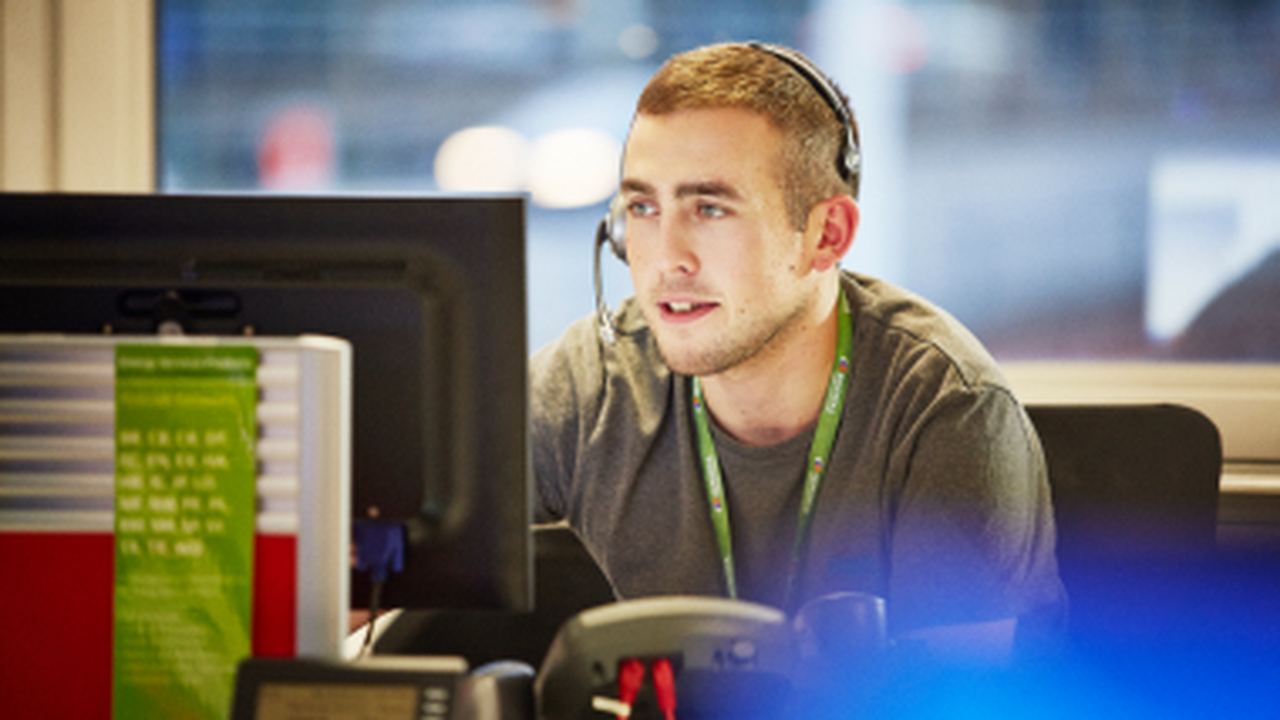 man working as a customer services agent on the phone to a customer