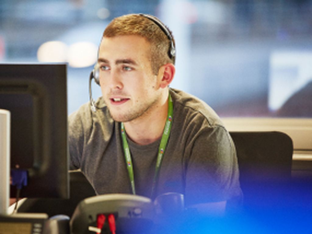 man working as a customer services agent on the phone to a customer