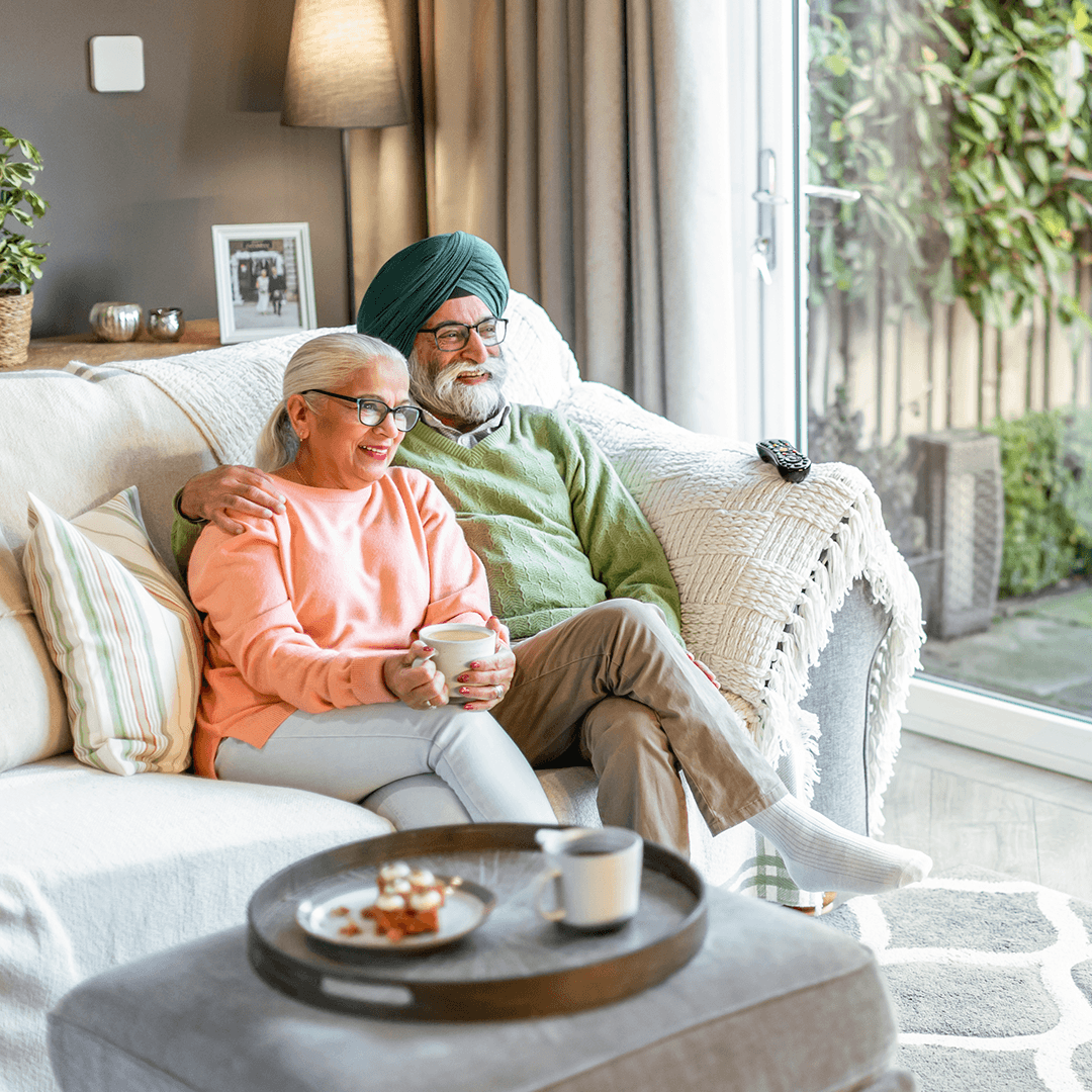 elderly couple sitting on the couch