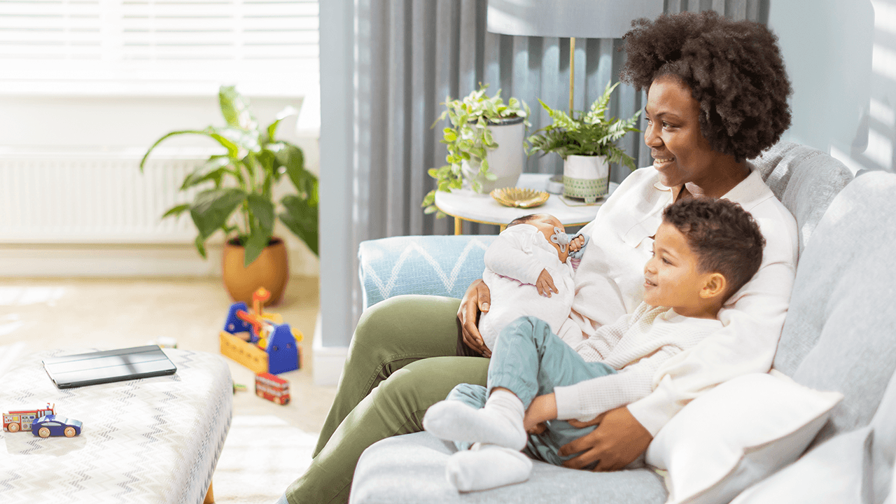 Family sitting on couch watching television