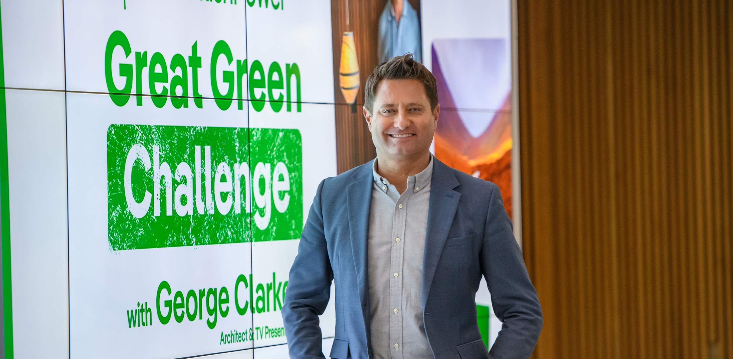 George Clarke stands in front of screen that reads Great Green Challenge