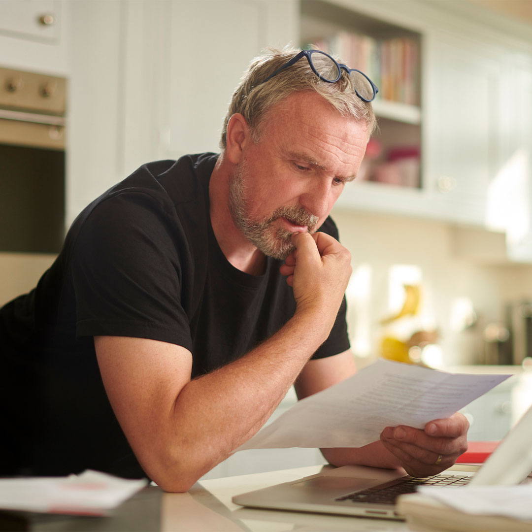 Man looking at letter