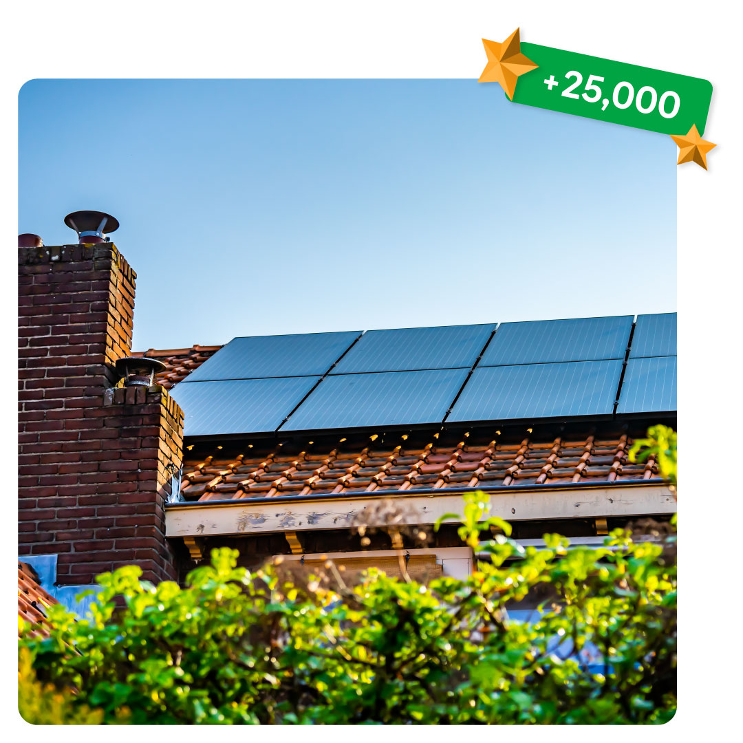 Solar panels installed on a tiled house roof under a clear blue sky, with a green ‘+25,000’ badge in the top corner.