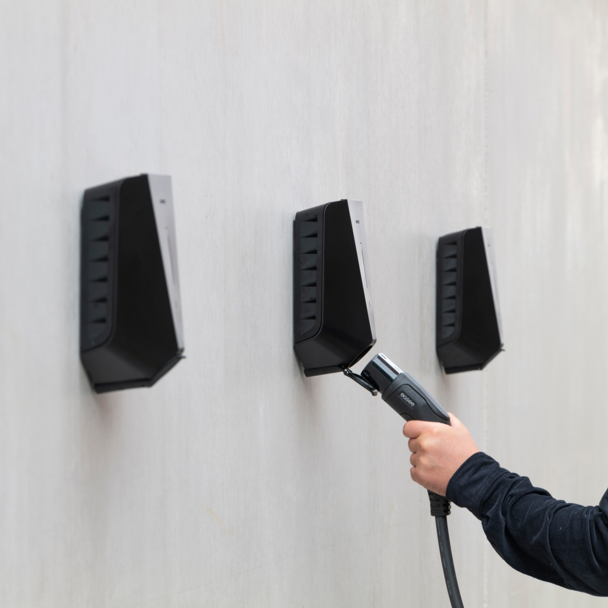 Person_plugging_charging_cable_back_into_Easee_EV_charger