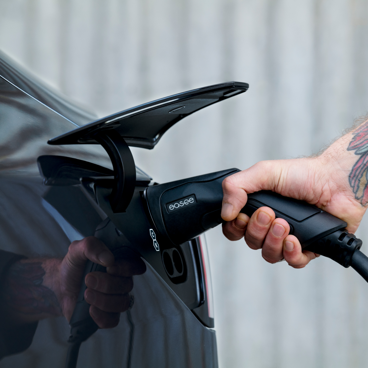 Person_plugging_in_Easee_EV_charger_to_their_car