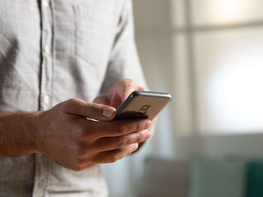 Close-up of a ScottishPower customer using their smartphone to submit a meter reading.