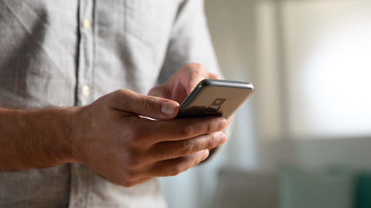 Close-up of a ScottishPower customer using their smartphone to submit a meter reading.