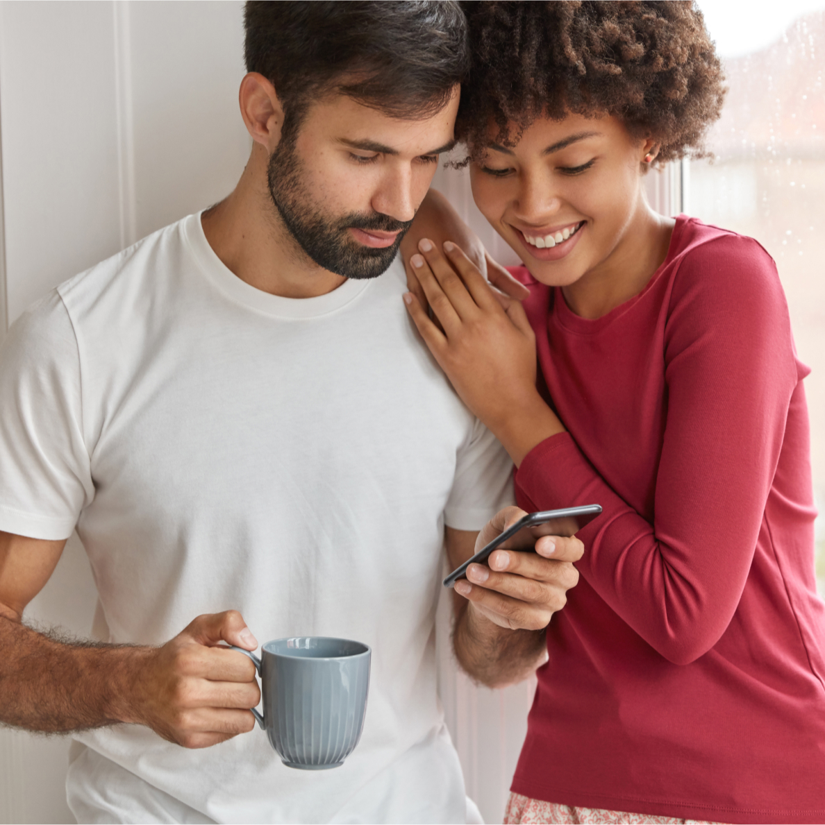 couple smiling looking at phone