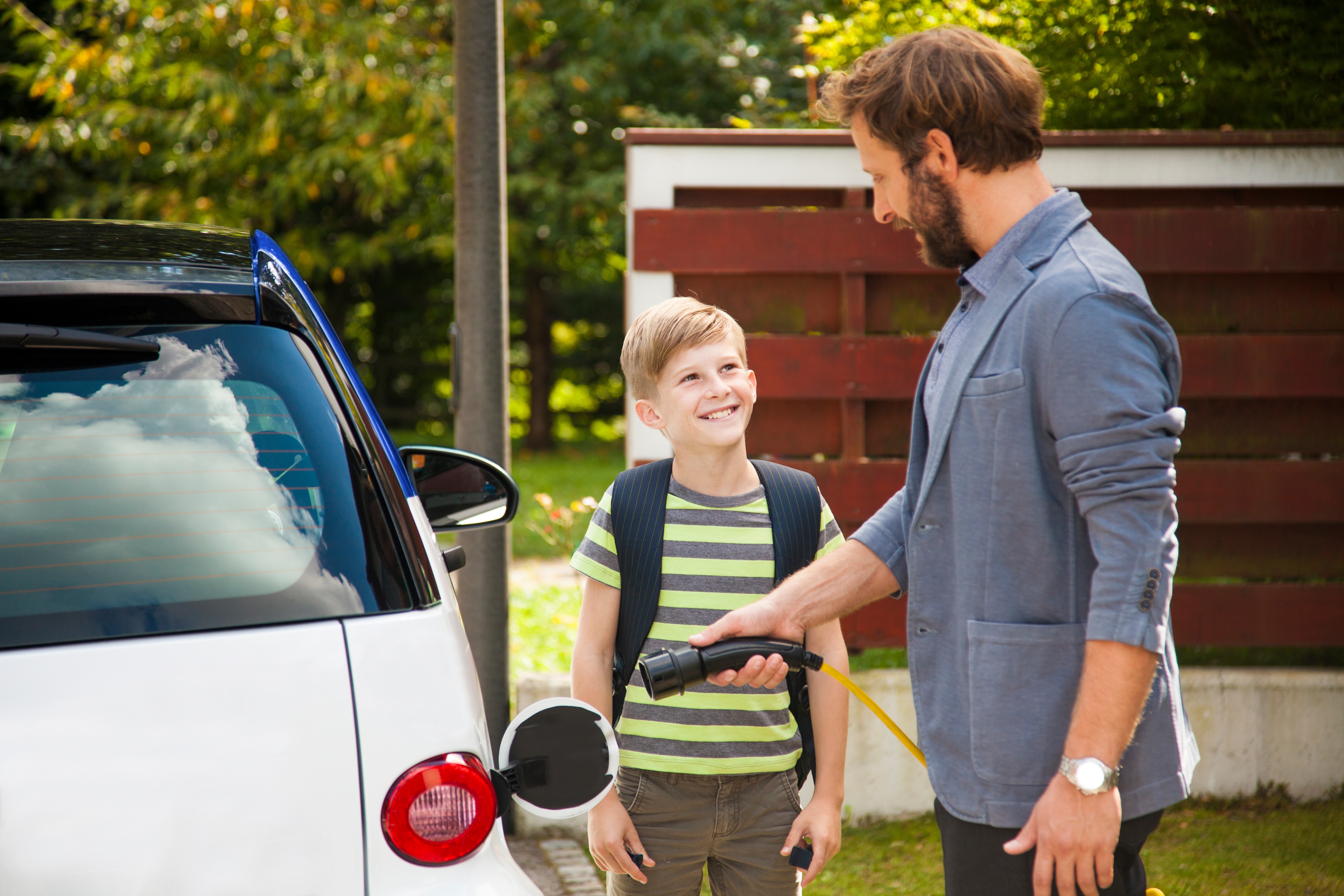 Man charging car at home
