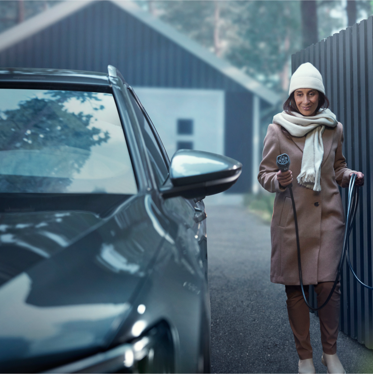 Winter woman charging car