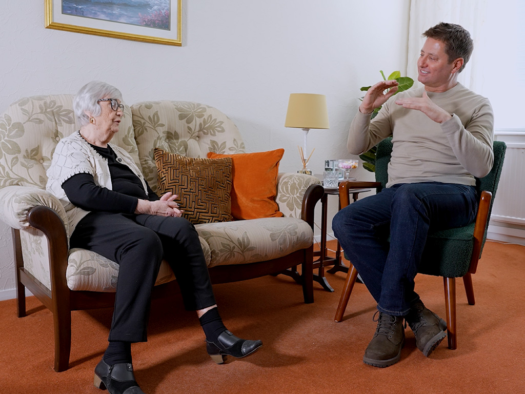 George Clarke in a living room discussing greener living with a ScottishPower customer