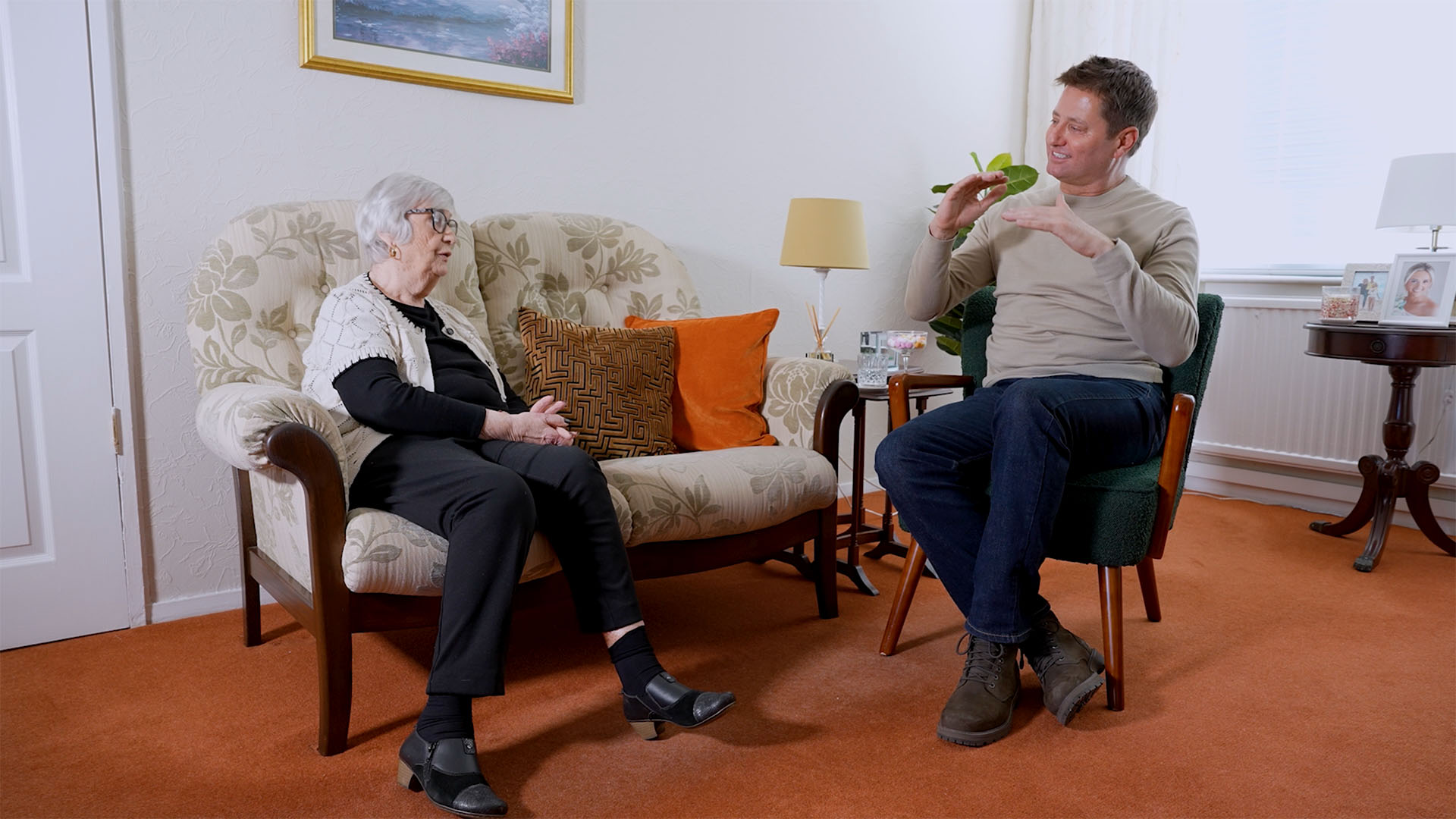 George Clarke in a living room discussing greener living with a ScottishPower customer