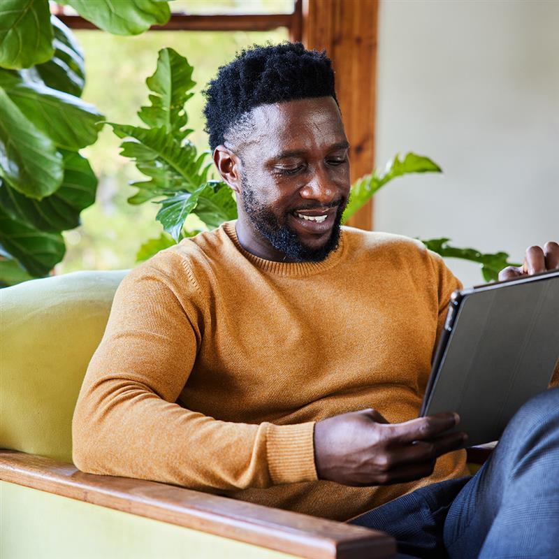 Man looking at his ipad smiling