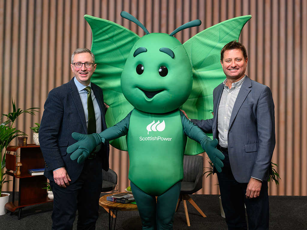 George Clarke and Andrew Ward, ScottishPower Customer Business CEO, standing with Bruce the butterfly (ScottishPower mascot)