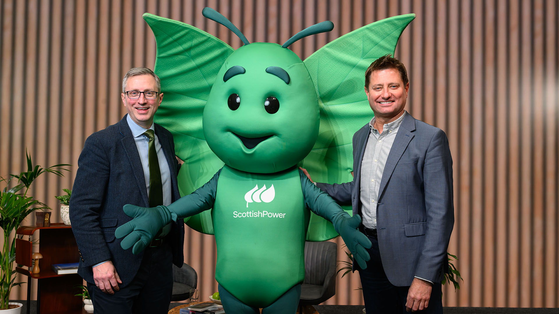 George Clarke and Andrew Ward, ScottishPower Customer Business CEO, standing with Bruce the butterfly (ScottishPower mascot)