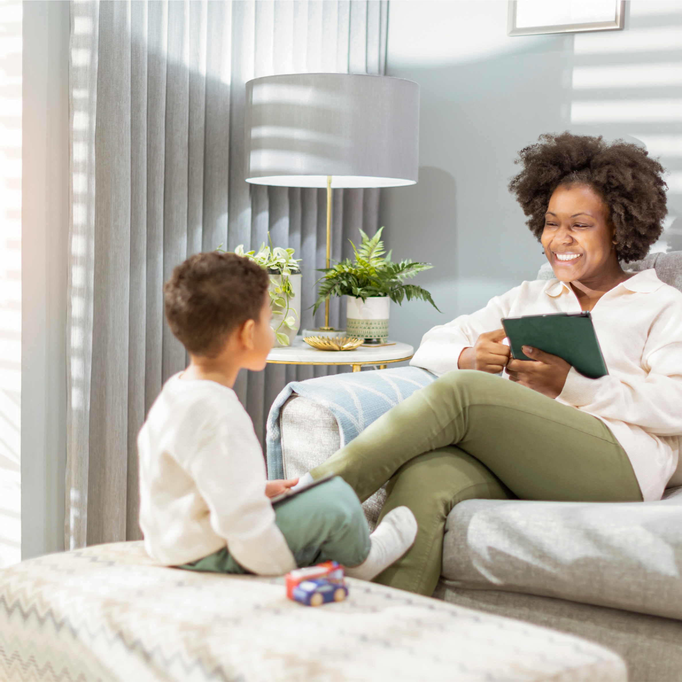 Woman and son sit on couch together